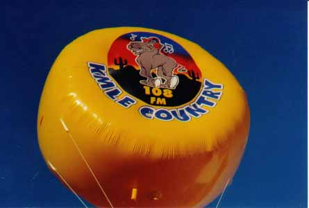 custom helium balloon - disc shape helium inflatable with radio station logo.
